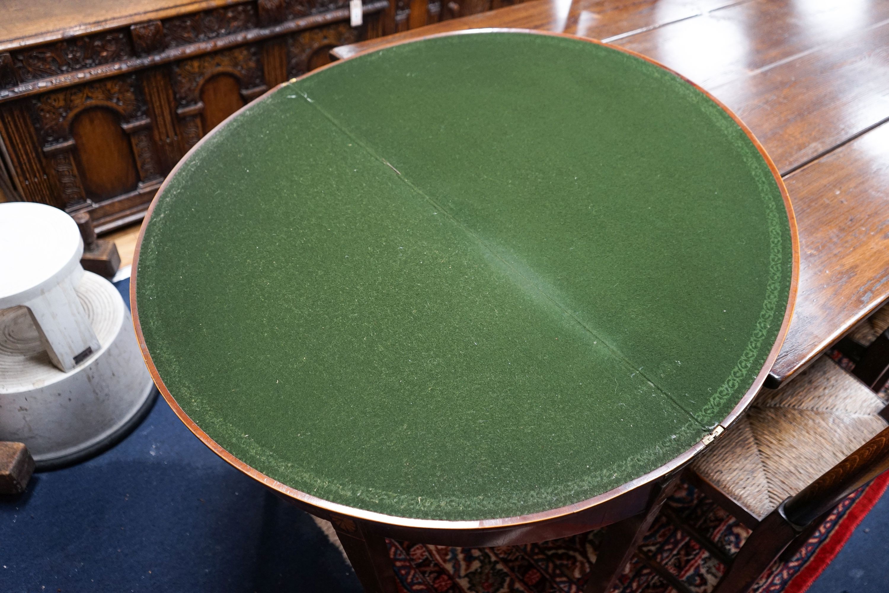 A George III inlaid and cross banded mahogany demi-lune card table with folding top, width 91cm, depth 44cm, height 72cm